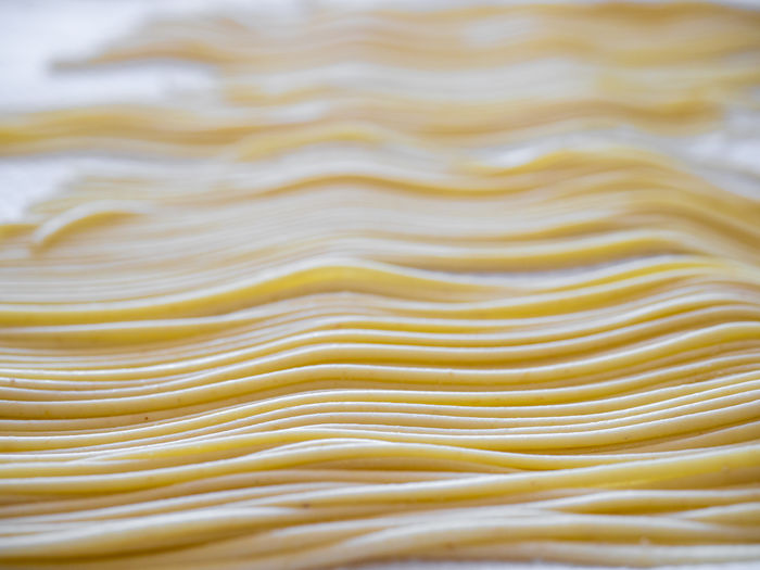 Freshly made spaghetti pasta drying on kitchen cloth
