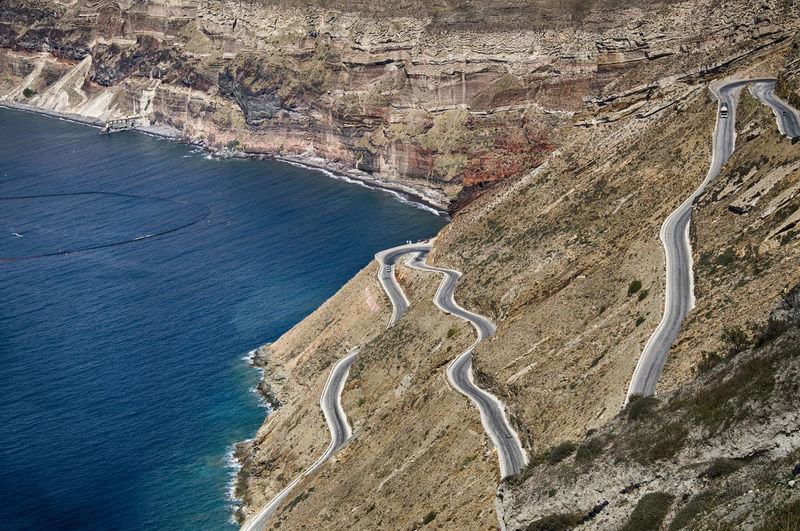 High angle view of mountain road by sea in santorini