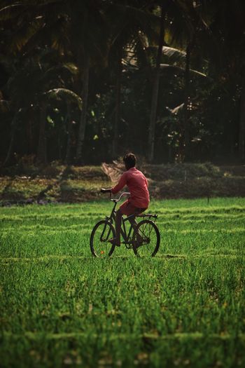 Man riding bicycle on field