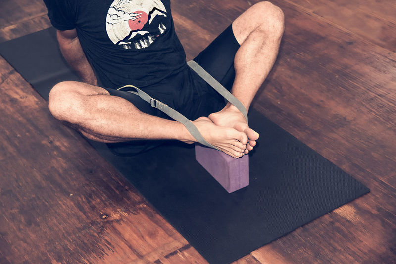 Low section of man exercising on hardwood floor