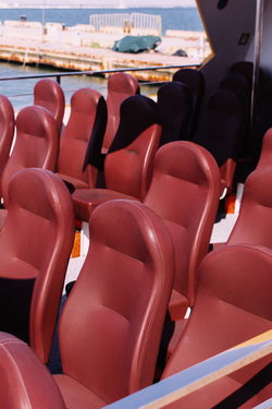 CLOSE-UP OF EMPTY CHAIRS IN ROW