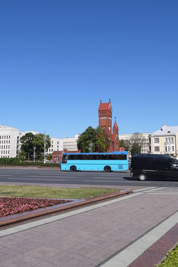View of buildings against clear blue sky