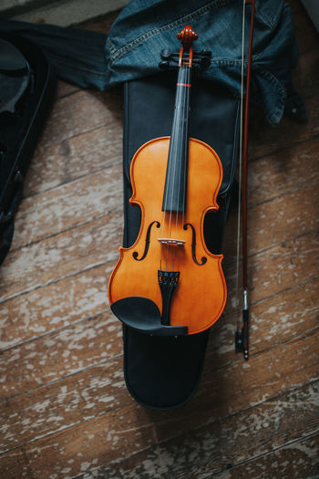 High angle view of violin on wooden table