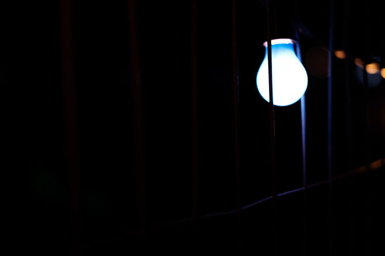 Close-up of illuminated light bulb in the dark