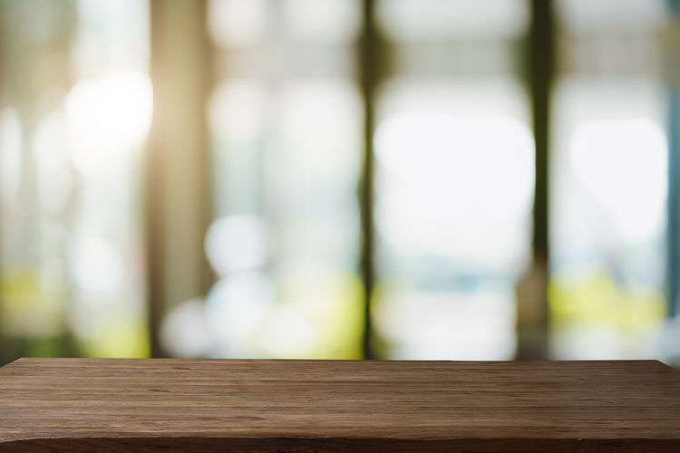 Close-up of railing on table against window