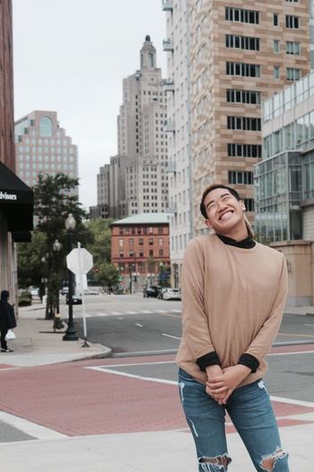 Full length of a smiling man standing in city