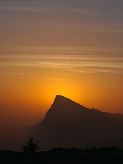 Scenic view of silhouette mountain against sky during sunset