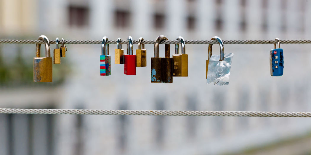 Close-up of love locks on cable