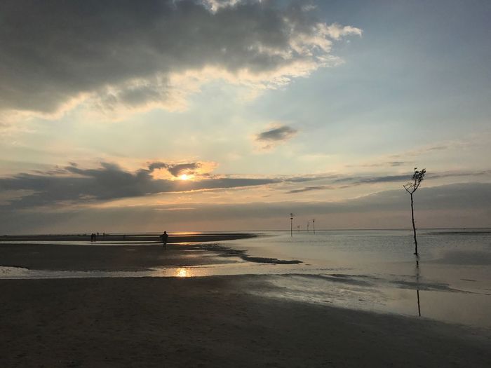 Scenic view of beach against sky during sunset