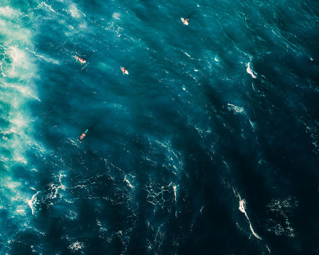 Blue background with surfers. drone photography water texture from the caribbean sea.