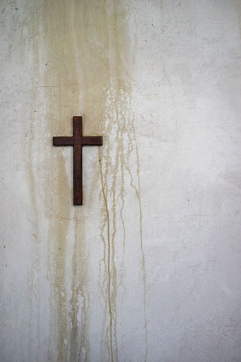 Close-up of cross on wall in building