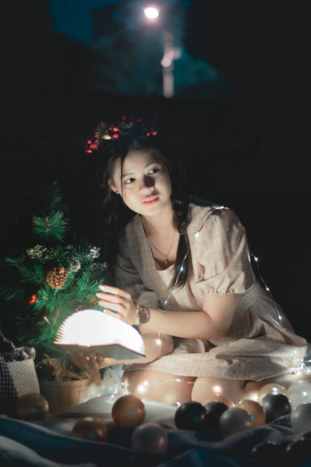 Portrait of woman with illuminated lights