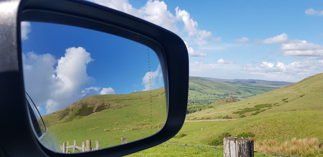 Panoramic view of landscape seen through car windshield