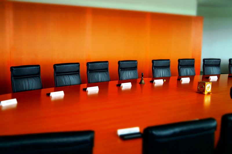 Empty chairs in board room at office