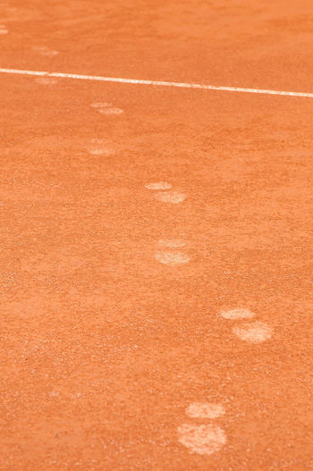 High angle view of footprints on tennis court
