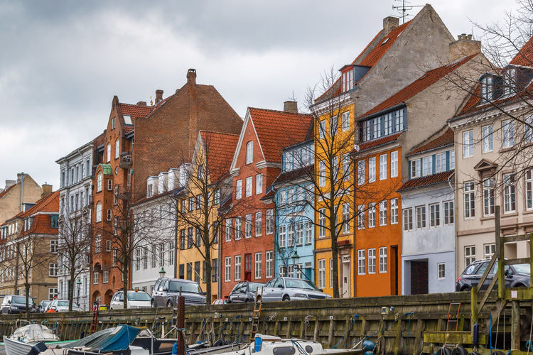 Colourful facade of building along canal in copenhagen city center, denmark