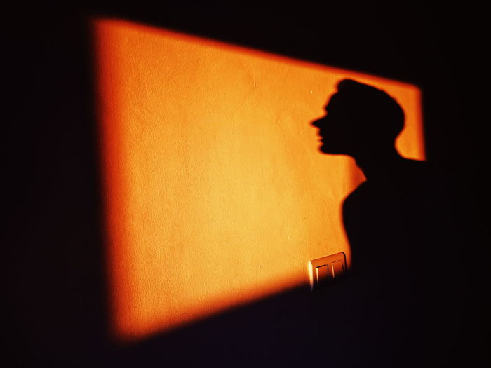 Shadow of man on wall at night