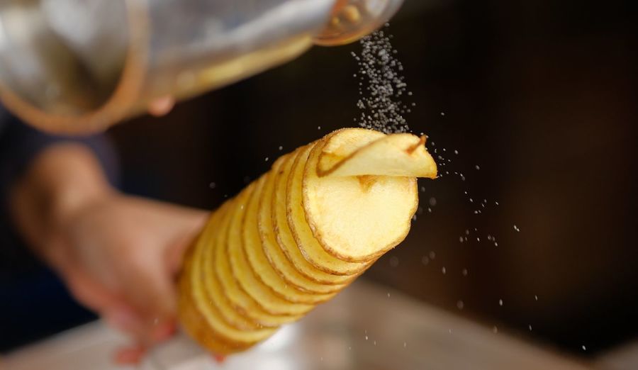 Close-up of salt sprinkling on potato snack
