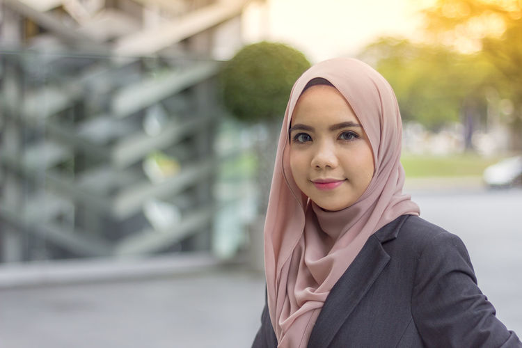 Portrait of confident businesswoman wearing headscarf in city