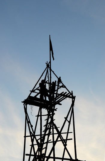 Low angle view of silhouette tower against sky at sunset
