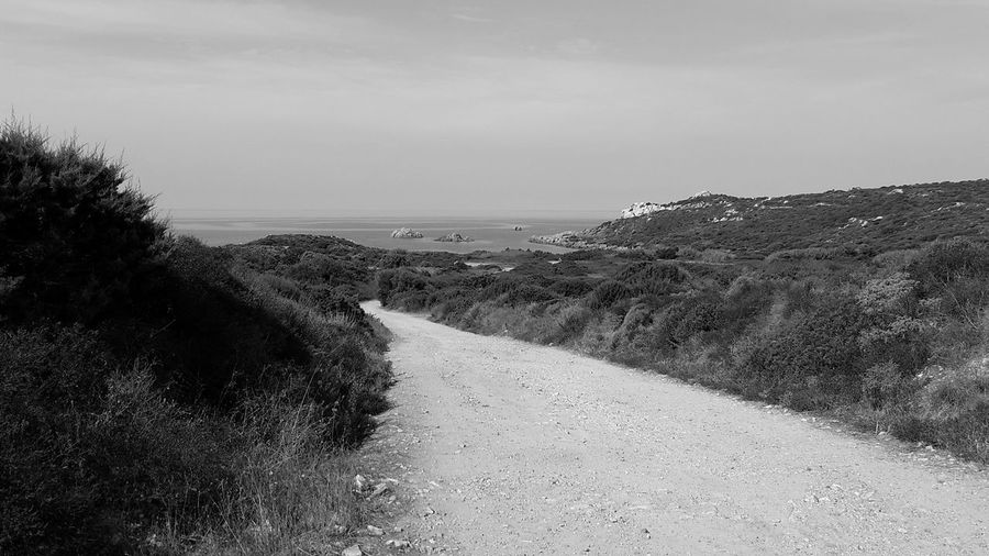 Road by sea against sky