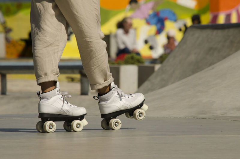 Low section of person roller skating outdoors