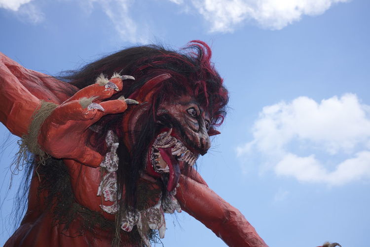 Low angle view of ogoh-ogoh demon statue against sky