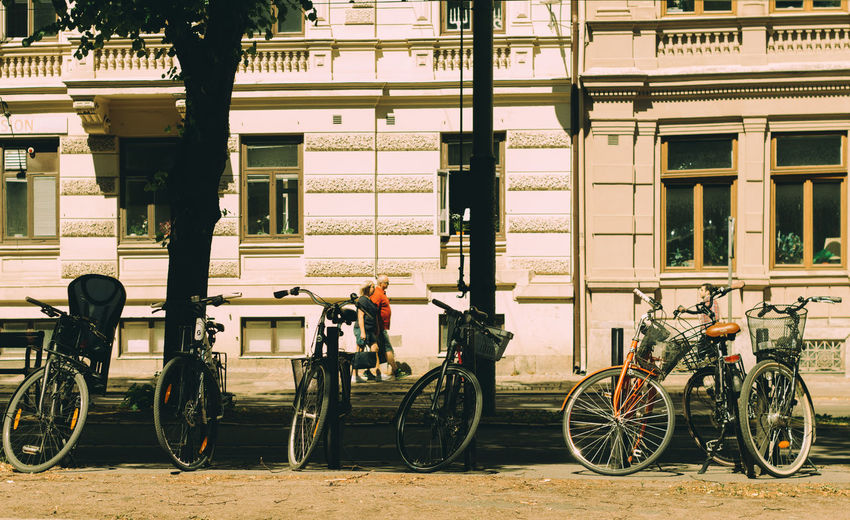 Bicycles on street against building in city