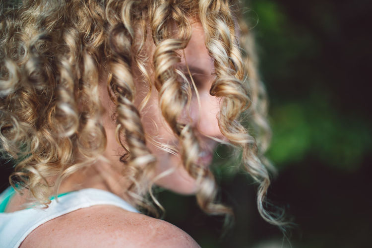 Close-up of woman with curly hair