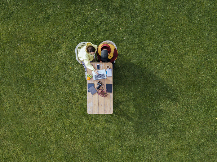 High angle view of personal accessories on grassy field