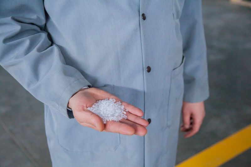 Close-up of hand holding white polystyrene balls