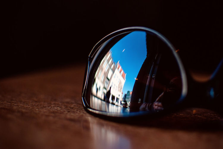 Reflection of building on sunglasses