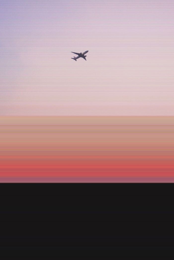 Low angle view of airplane against sky during sunset
