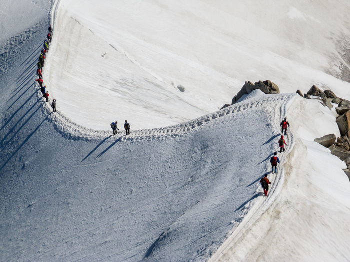 People walking on snowcapped mountain