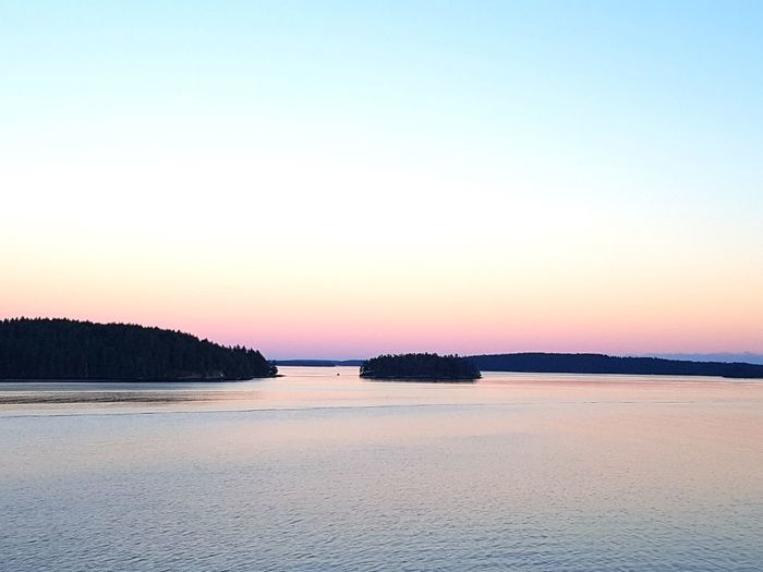 Scenic view of sea against clear sky during sunset
