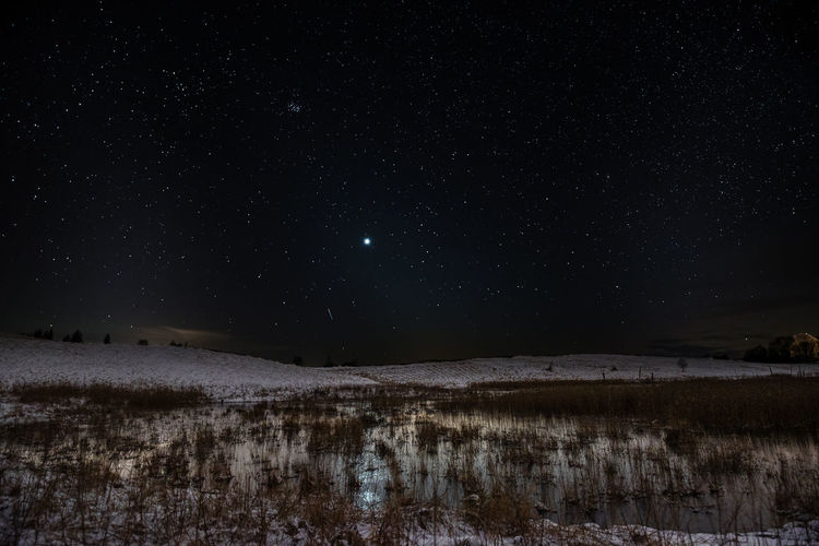 Scenic view of lake against star field at night