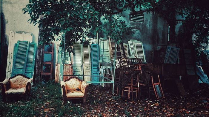 Abandoned armchairs and doors on ground