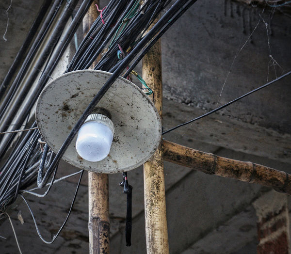 High angle view of electric lamp hanging on pole