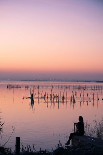 Young girl enjoying the sunset at valencia albufera against the light
