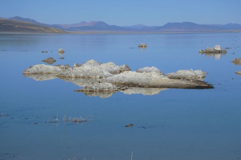 Scenic view of lake against blue sky