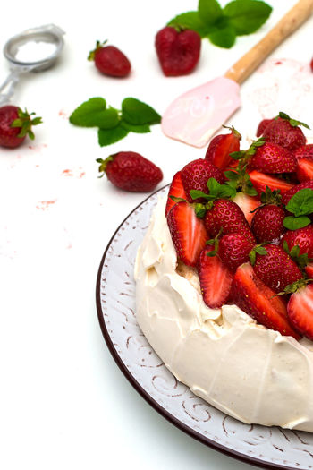 Homemade cake pavlova with strawberries on top - sweet food