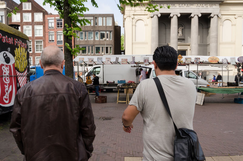 Betondorp, netherlands, amsterdam. outdoor market on street two men walking