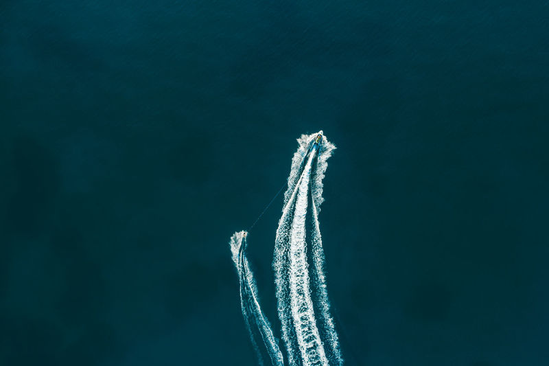 Aerial view of people jet boating in sea