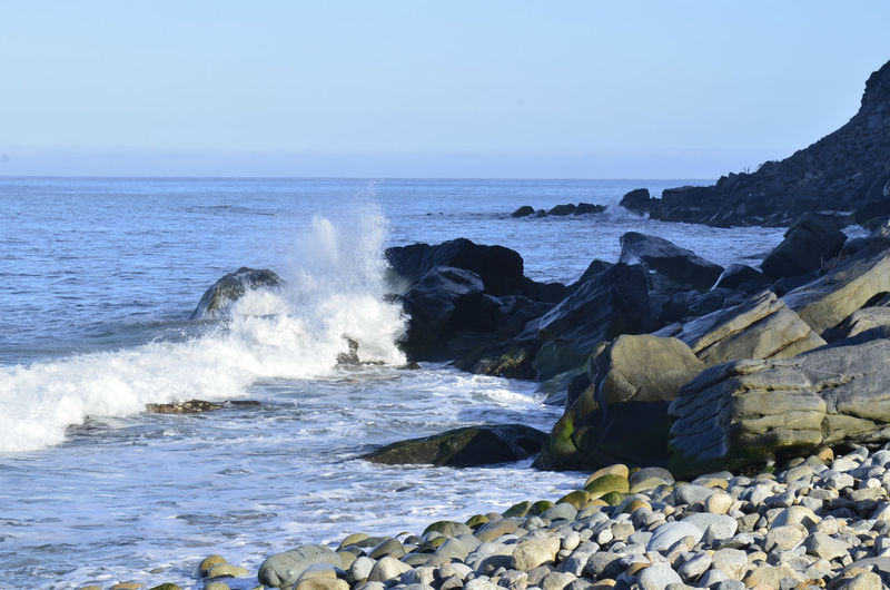 Pacific ocean waves splash,and spray against rocks on coast of baja california sur, mexico