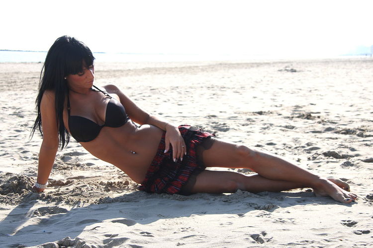 Full length of woman relaxing at beach