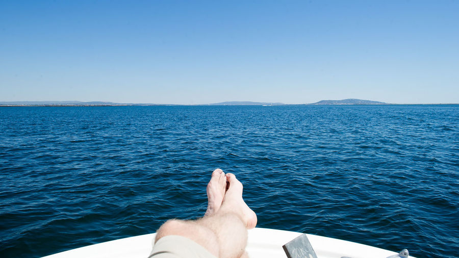 Scenic view of man relaxing on boat