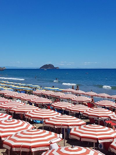 Scenic view of beach against clear blue sky