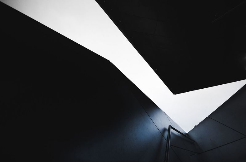 A tubular railing leading to an opening in a modern building