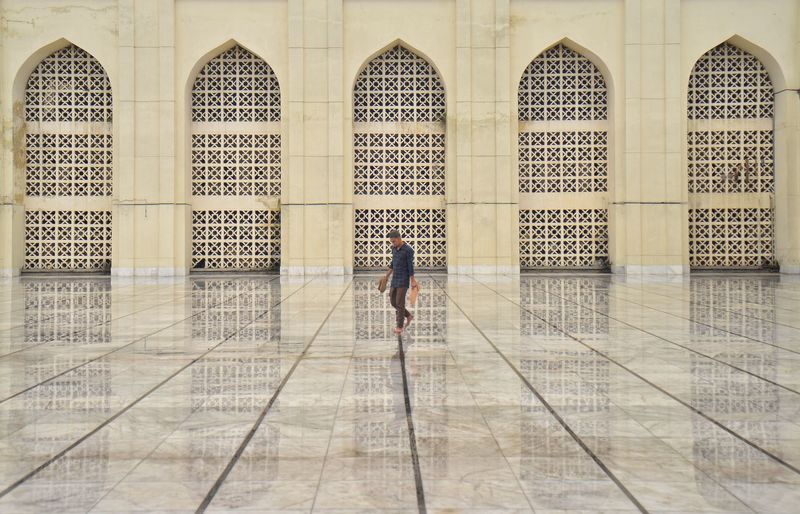 Full length of man walking on tiled floor