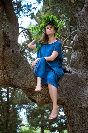 Full length of woman in tree trunk
